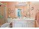 Well-lit bathroom featuring a white vanity, decorative accents, and a glass-enclosed shower at 1145 Prospect Mill Dr, Lawrenceville, GA 30043