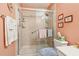 Bathroom featuring a glass-enclosed shower with shelving and decorative accents on the walls at 1145 Prospect Mill Dr, Lawrenceville, GA 30043