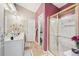 Bathroom featuring double sinks, white cabinets, a gold-trimmed shower, and warm-toned tile flooring at 1145 Prospect Mill Dr, Lawrenceville, GA 30043