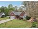 Charming one-story brick home featuring an attached garage, a well-manicured lawn, and lovely landscaping at 1145 Prospect Mill Dr, Lawrenceville, GA 30043