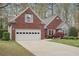 Charming brick home with attached garage, landscaped front yard, and well-maintained lawn at 1145 Prospect Mill Dr, Lawrenceville, GA 30043