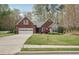 Lovely one-story brick home featuring an attached garage, manicured lawn, and a beautifully landscaped front yard at 1145 Prospect Mill Dr, Lawrenceville, GA 30043
