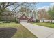 A one-story brick home featuring an attached garage, long driveway, and a well-maintained lawn at 1145 Prospect Mill Dr, Lawrenceville, GA 30043