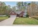 Charming brick home featuring an attached garage, long driveway, and a beautifully landscaped front yard at 1145 Prospect Mill Dr, Lawrenceville, GA 30043