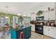 Eat-in kitchen boasting an island, black appliances, and a view to the sunroom at 1145 Prospect Mill Dr, Lawrenceville, GA 30043