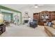Comfortable living room includes a fireplace, built-in shelves, and sunroom access at 1145 Prospect Mill Dr, Lawrenceville, GA 30043