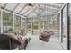 Enclosed porch with wicker furniture and a porch swing offering a relaxing outdoor space at 1145 Prospect Mill Dr, Lawrenceville, GA 30043