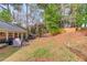 A spacious backyard with patio, grassy areas, and mature trees at 2643 Herndon Nw Rd, Lawrenceville, GA 30043