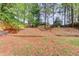 A spacious backyard with grassy areas and mature trees for shade at 2643 Herndon Nw Rd, Lawrenceville, GA 30043