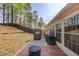 A spacious backyard with grassy areas, brick patio, and mature trees at 2643 Herndon Nw Rd, Lawrenceville, GA 30043