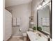 Bathroom offering vanity with a large mirror, decorative shelving and a shower with a curtain at 2643 Herndon Nw Rd, Lawrenceville, GA 30043