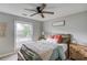This bedroom has a large window, ceiling fan and is decorated in soft neutral colors at 2643 Herndon Nw Rd, Lawrenceville, GA 30043