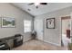 This carpeted room features a window with blinds, ceiling fan, and a door leading to another room at 2643 Herndon Nw Rd, Lawrenceville, GA 30043