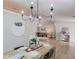 Open dining area with wood floors, modern chandelier and view into the living room at 2643 Herndon Nw Rd, Lawrenceville, GA 30043