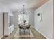 Bright dining area with wood floors, a modern chandelier, and views of the backyard at 2643 Herndon Nw Rd, Lawrenceville, GA 30043