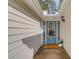 Inviting front entry featuring a teal door with glass panes, sidelights, and neutral siding at 2643 Herndon Nw Rd, Lawrenceville, GA 30043