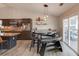Beautiful kitchen with dark wood cabinets, stainless steel appliances, and a stylish eat-in dining area with access to patio at 2643 Herndon Nw Rd, Lawrenceville, GA 30043