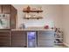 Entertainers kitchen featuring stainless appliances, beverage fridge, bar cart and shelving for glasses at 2643 Herndon Nw Rd, Lawrenceville, GA 30043