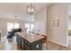 Bright kitchen featuring an island with seating, modern lighting, and a seamless connection to the dining area for easy entertaining at 2643 Herndon Nw Rd, Lawrenceville, GA 30043