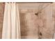 Modern shower featuring light brown tiled walls and a shower curtain at 2643 Herndon Nw Rd, Lawrenceville, GA 30043