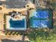 Aerial shot highlighting community amenities: a pool, tennis courts, parking, and mature landscaping at 416 Pine Log Ct, Canton, GA 30115