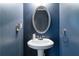 Pedestal sink in bathroom featuring a stylish oval mirror and modern fixtures at 416 Pine Log Ct, Canton, GA 30115