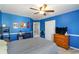 Spacious blue bedroom with white trim, wooden dresser, TV and ceiling fan at 416 Pine Log Ct, Canton, GA 30115