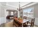 Bright dining room with a chandelier, wood table and bench seating, and large windows at 416 Pine Log Ct, Canton, GA 30115