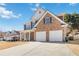 Charming two-story home with brick and siding, inviting front porch, and a two-car garage at 416 Pine Log Ct, Canton, GA 30115