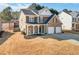 Charming two-story home with a two-car garage, inviting front porch, and meticulously landscaped yard at 416 Pine Log Ct, Canton, GA 30115