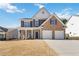 Charming two-story home with brick and siding, inviting front porch, and a two-car garage at 416 Pine Log Ct, Canton, GA 30115