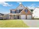 Charming two-story home with brick and siding, inviting front porch, and a two-car garage at 416 Pine Log Ct, Canton, GA 30115