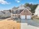 Two-story home with brick and siding exterior, covered front porch, and a two-car garage at 416 Pine Log Ct, Canton, GA 30115