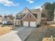 Two-story home with brick and siding exterior, large driveway, and a two-car garage at 416 Pine Log Ct, Canton, GA 30115