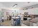 Bright kitchen with island, white cabinets, stainless appliances, and adjacent dining area at 416 Pine Log Ct, Canton, GA 30115