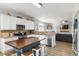Modern kitchen with center island, stainless appliances, and open to the living area at 416 Pine Log Ct, Canton, GA 30115