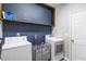 Laundry room featuring modern washer and dryer units and useful overhead shelving at 416 Pine Log Ct, Canton, GA 30115