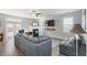 Cozy living room with a large sectional sofa, ceiling fan, fireplace and a mounted TV at 416 Pine Log Ct, Canton, GA 30115