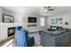 Comfortable living room features a fireplace, large TV, ceiling fan and neutral decor at 416 Pine Log Ct, Canton, GA 30115