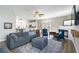 Open concept living room with fireplace, TV, ceiling fan and view to the kitchen at 416 Pine Log Ct, Canton, GA 30115