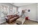 Comfortable living room with natural light and a leather sofa at 416 Pine Log Ct, Canton, GA 30115