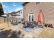Backyard patio area includes dining table, seating, umbrella, grill, and partially fenced lawn at 416 Pine Log Ct, Canton, GA 30115