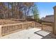 Home backyard featuring new wooden deck, fenced yard, and wooded backdrop at 508 Sutters Mill Rd, Stone Mountain, GA 30087
