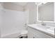 Bathroom featuring tub/shower combo, tile and single vanity with solid surface countertop at 508 Sutters Mill Rd, Stone Mountain, GA 30087