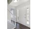 Bright foyer featuring wood-look flooring, a staircase, and a white front door with glass inserts at 508 Sutters Mill Rd, Stone Mountain, GA 30087