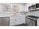 Modern kitchen featuring stainless steel appliances, white cabinetry, and granite countertops at 508 Sutters Mill Rd, Stone Mountain, GA 30087