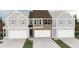New two-story townhome featuring a brick facade, attached two-car garage, and manicured landscaping at 6354 Towhee Way, Morrow, GA 30260