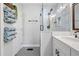 Bathroom featuring a glass enclosed shower, double sink vanity and linen closet at 2742 Oakland Ter, Decatur, GA 30032