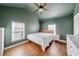 Bedroom with hardwood floors, ceiling fan, and two windows for natural light at 2742 Oakland Ter, Decatur, GA 30032