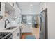Open kitchen featuring stainless steel appliances, white cabinets, and a view into the living area at 2742 Oakland Ter, Decatur, GA 30032